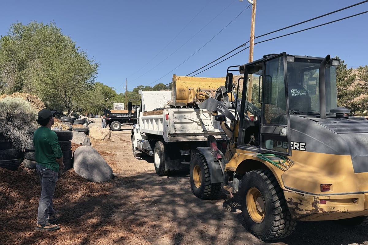 Loader filling a dump truck on a job site