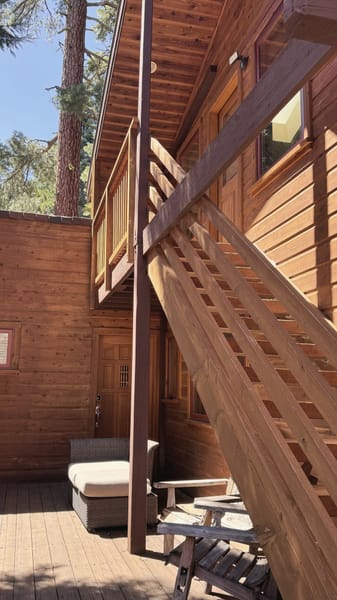 Exterior wooden stairs beside a cabin
