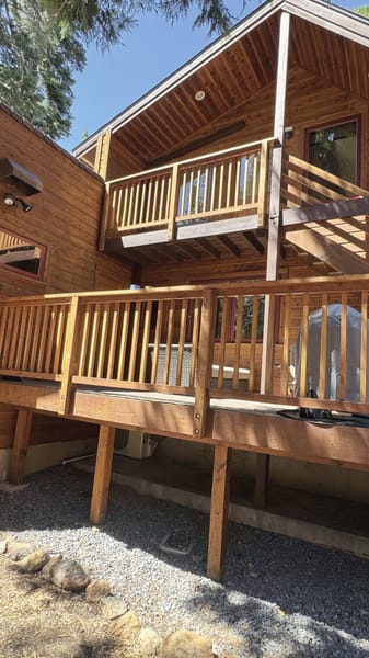 Multi-level decks with wooden railings on a cabin