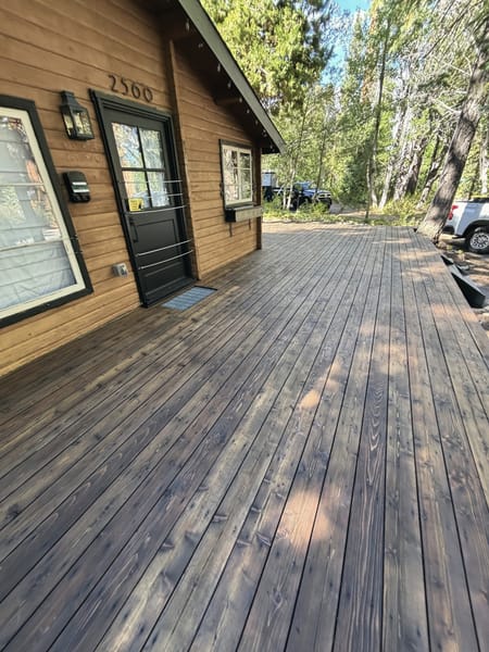 Long stained deck along a cabin wall