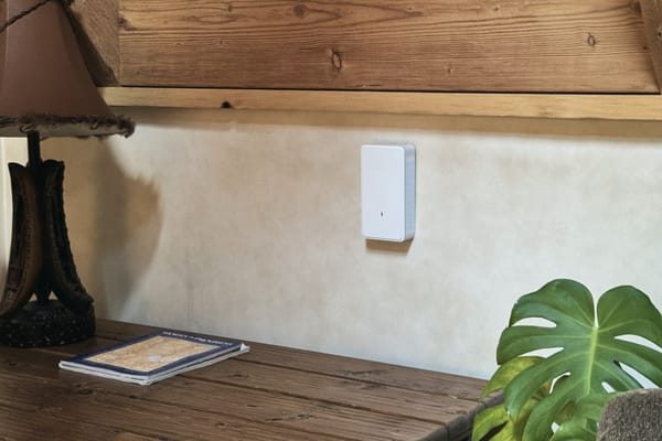 Wall-mounted Wi-Fi access point above a desk