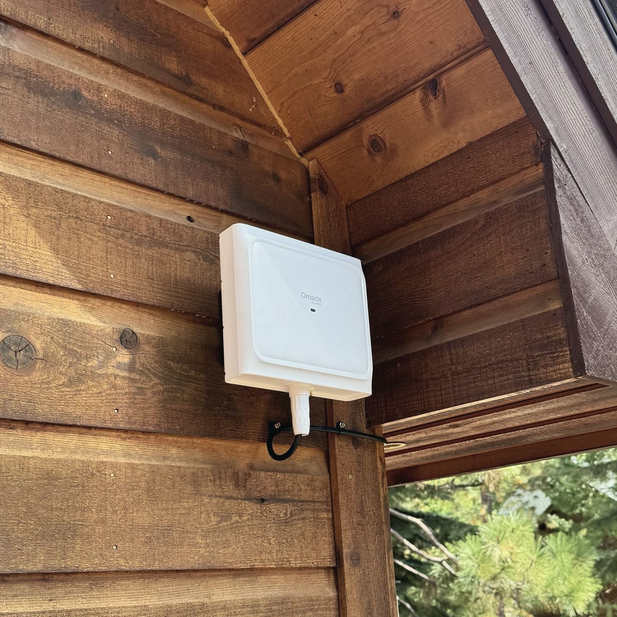 Outdoor Wi-Fi access point mounted under a cabin eave