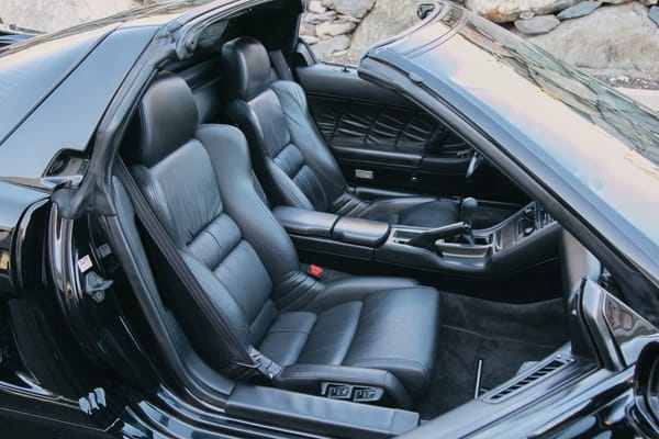 Black leather seats of a sports car with its roof off