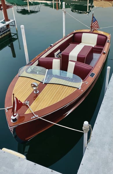 Wooden runabout boat at a dock